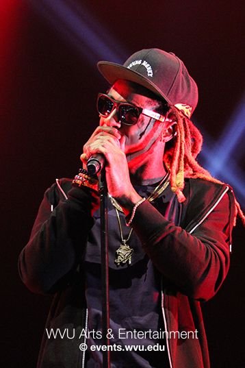 Lil Wayne sings on stage at the Coliseum in 2017