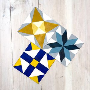 paintings that look like quilt squares in blues, golds 