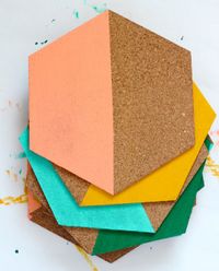 cork boards painted yellow, aqua, green and peach in color