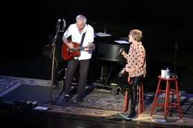 Neil Giraldo and Pat Benatar performing on stage at the WVU Creative Arts Center.