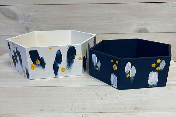 hexagon-shaped trays painted in blues, golds and whites
