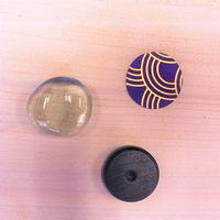 Black magnet, clear cover and paper with purple and gold pattern for making patterned magnets