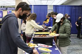 Students serving themselves in the buffet line in the Mountainalr Commons Area.