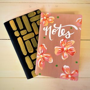 custom painted notebooks in black and gold, and a floral pattern