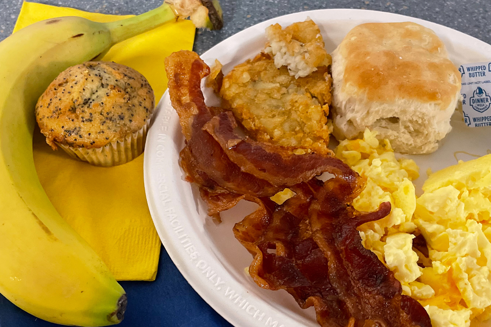 Breakfast plate with eggs, bacon and a biscuit