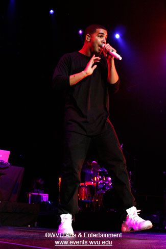 Drake, all in black expect for white tennis shoes, sings during his 2010 concert at the Coliseum.