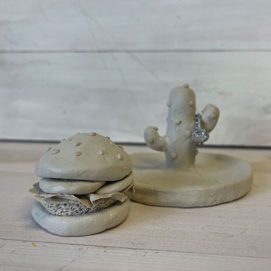 Air dry clay sculptures in the shape of a cheeseburger and a cactus