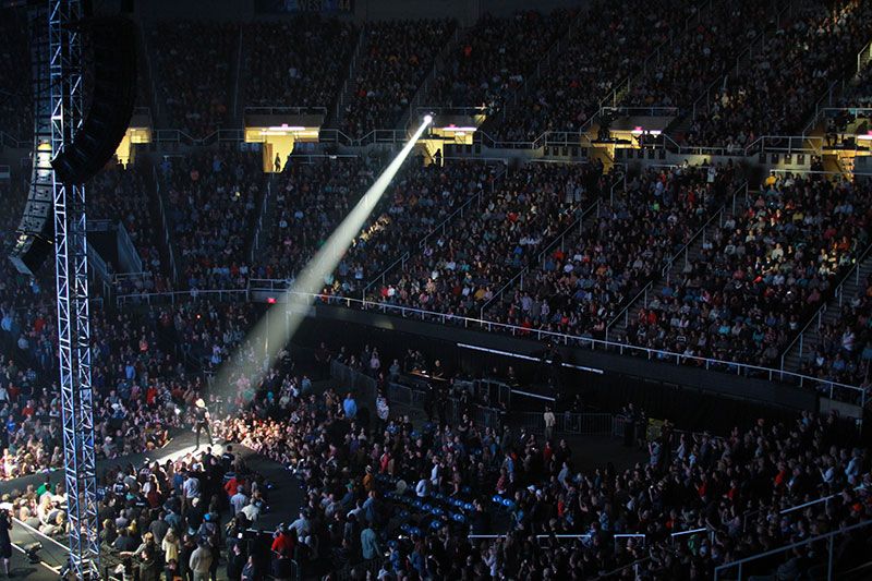 Wide shot of the Coliseum with Brad Paisley on stage showing a packed arena.