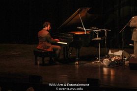 A member of His International All Stars performing on stage at the WVU Creative Arts Center. Photo by Logan McMasters.