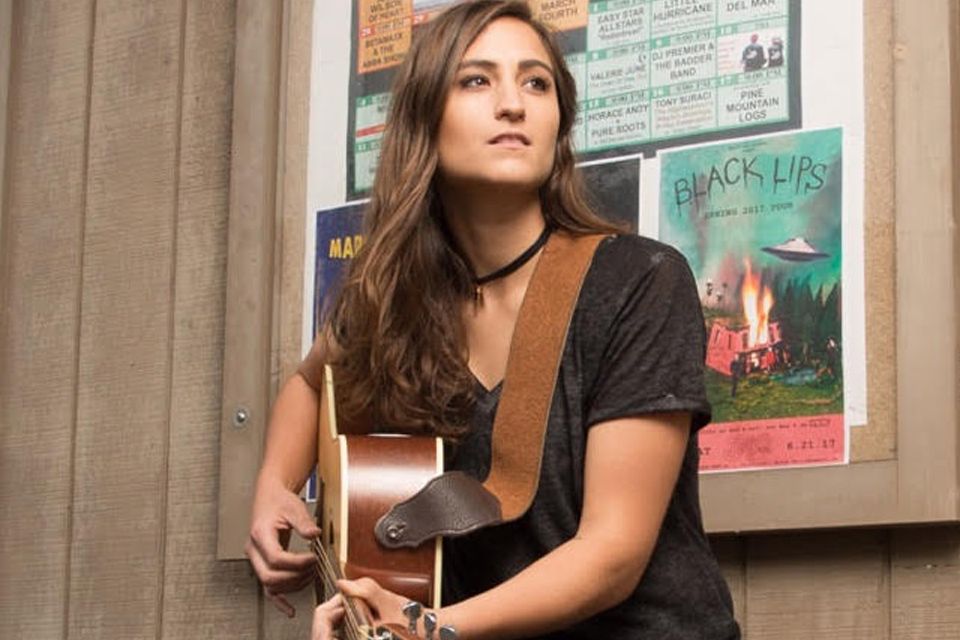 Singer/songwriter Angie K playing guitar