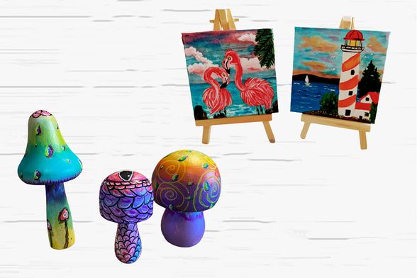 Mini wooden mushrooms painted with glow-in-the-dark paint. Canvas on an easel depicting two flamingos. Canvas on an easel depicting a lighthouse by the sea.