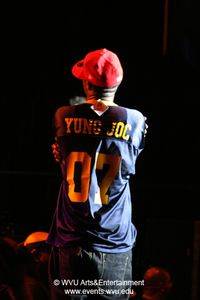 Yung Joc wearing a WVU Football jersey commemorating his performance at the Coliseum in 2007