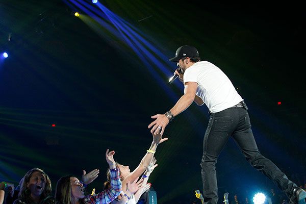 Luke Bryan interacting with fans in the pit