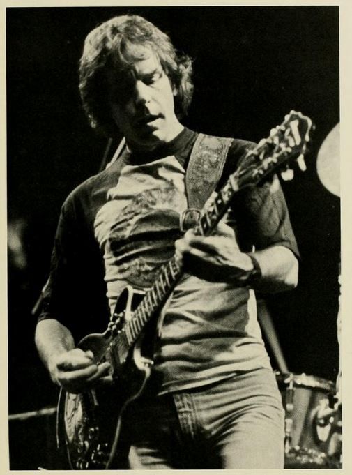 Photo from the 1983 Monticola depicting Bob  Weir playing guitar on the Coliseum stage.