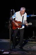 Neil Giraldo performing on stage at the WVU Creative Arts Center.