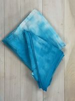 Photo of a dip-dyed bandana that is blue and white