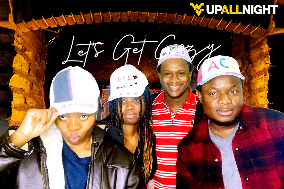 A group of African American students pose for a photo at the photo booth