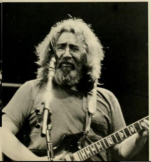 Jerry Garcia plays guitar during the Coliseum concert in 1983. Black and white photo from the Monticola