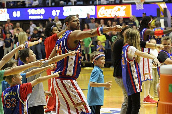 A member of the Globetrotters dancing with children from the audience.