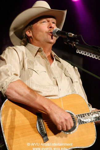 Close up of Alan Jackson sings while playing guitar in 2009