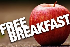 Text "free breakfast" on a brown background that includes a red apple.