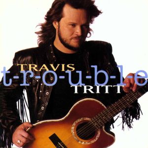 Travis Tritt's T R O U B L E album cover featuring a photo of Tritt with his guitar.