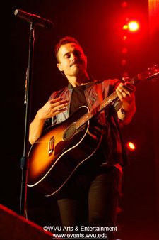 Joe King of The Fray plays guitar on stage at the WVU Coliseum in 2009