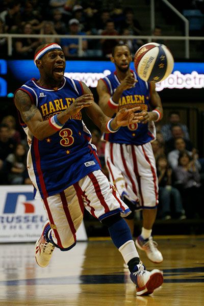 Two members of the Globetrotters move down the floor with the ball
