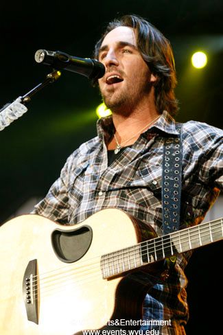 Jake Owen sings while holding his guitar in 2009