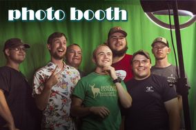 Group of males in front of the photo booth green screen