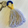 keychain made from blue, gold and white yarn