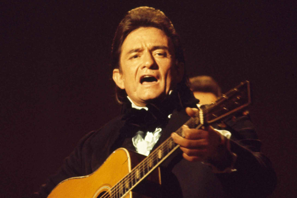 Archived photo of Johnny Cash playing guitar.