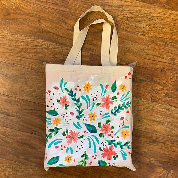 Custom painted white tote bag with colorful flowers