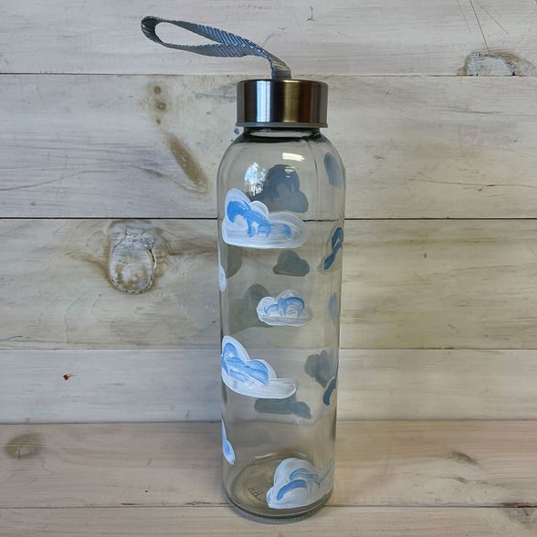 Glass water bottle painted with blue and white clouds